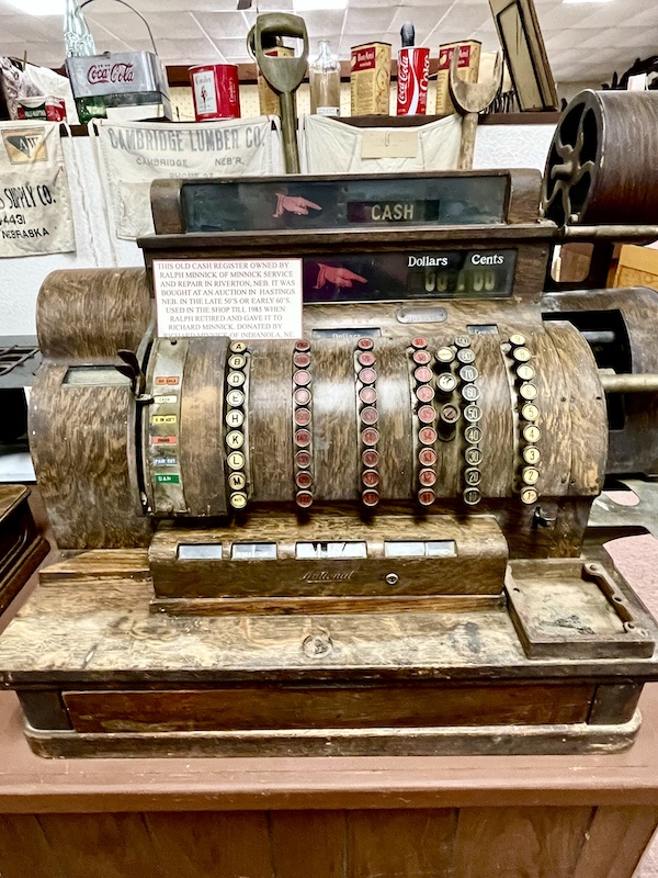 Antique wood cash register with metal trim on display at Nebraska's Cambridge Museum