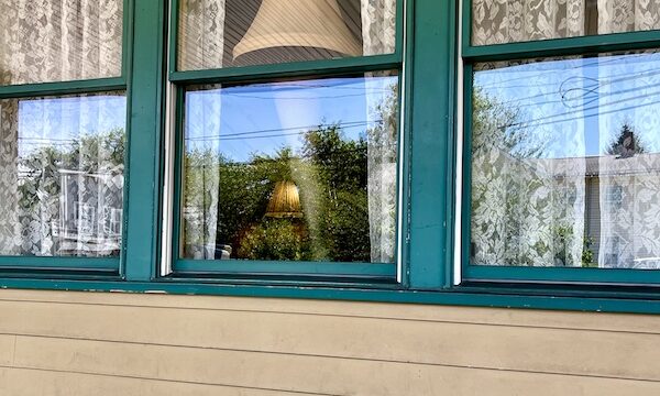 Window of The Christmas Story House with leg lamp on display.