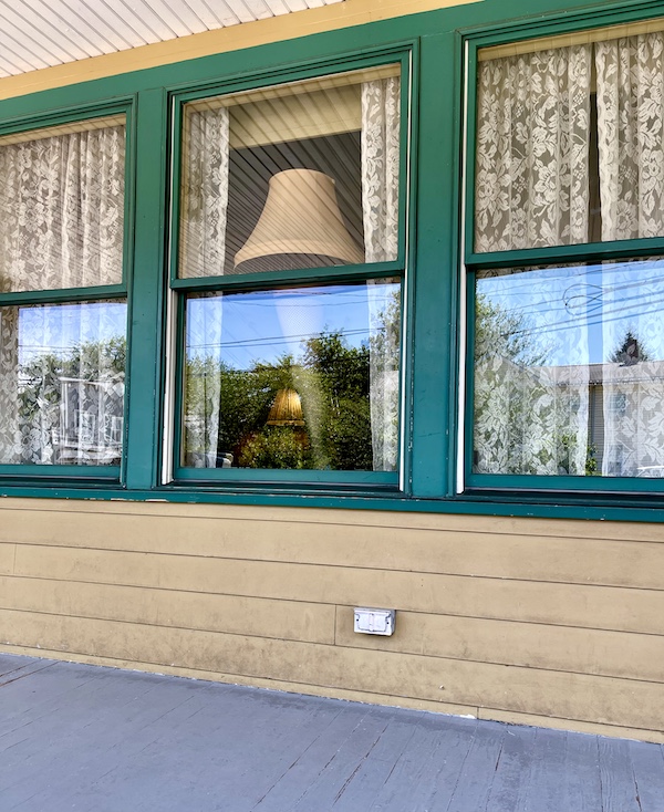 Window of The Christmas Story House with leg lamp on display.
