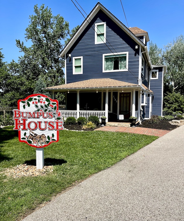 Charcoal gray house with white trim is where the Bumpus hounds lived next door to The Christmas Story House