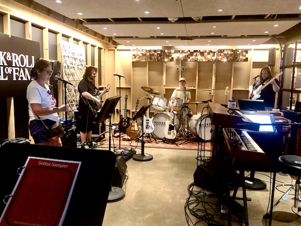 Visitors to Rock and Roll Hall of Fame performing in a sound room