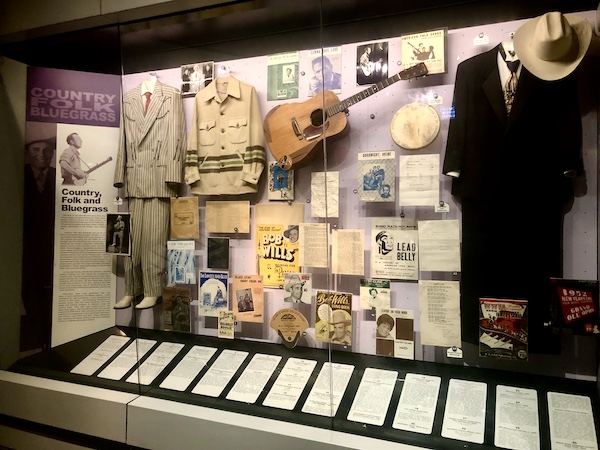 Costumes and instruments of Country, Folk and Bluegrass musicians on display at Rock and Roll Hall of Fame