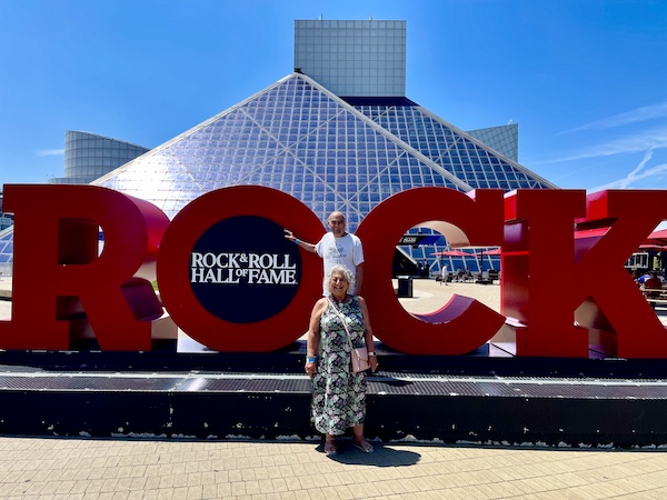 Steve and I standing in front of large red letters spelling Rock that welcome you to the Rock and Roll Hall of Fame