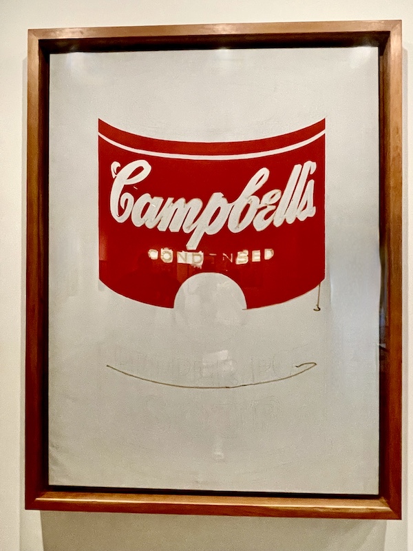 Red and white painting of parts of a soup can by Andy Warhol
