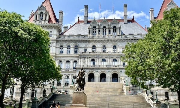 Romanesque Revival building with lots of steps leading to it, houses NY State Capitol in Upstate New York