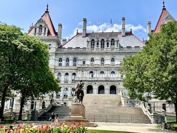 Romanesque Revival building with lots of steps leading to it, houses NY State Capitol in Upstate New York
