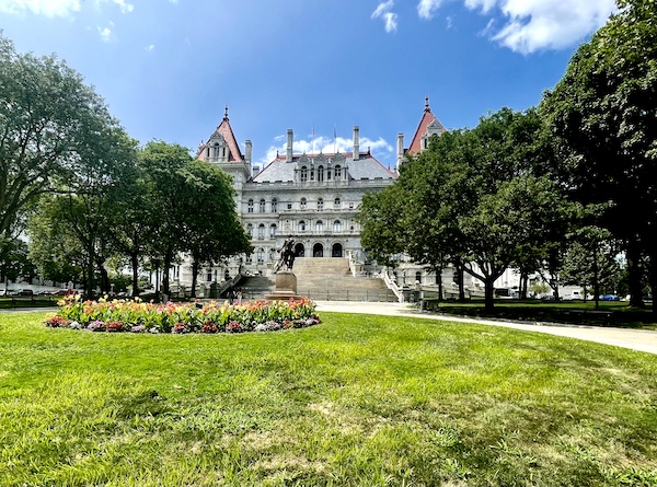 Beautiful lawn with plants and trees in front of NY Capitol building in Upstate New York