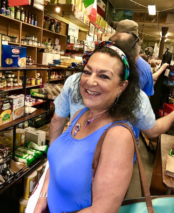 Me with dark hair and a purple top inside Central Grocery from 2017