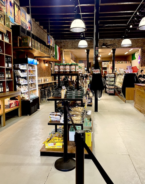 Spacious aisles and counter seating inside Welcome Back Central Grocery NOLA