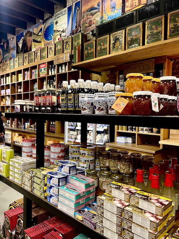Wood cubicles holding jam and jelly jars with other ingredients Welcome Back Central Grocery NOLA