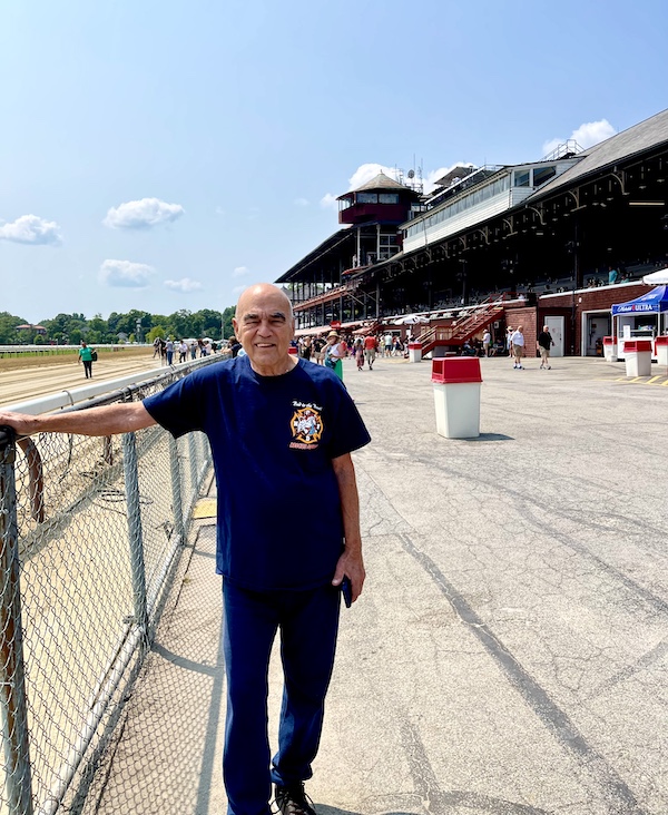 Steve standing at fence by track at Historic Saratoga Race Course