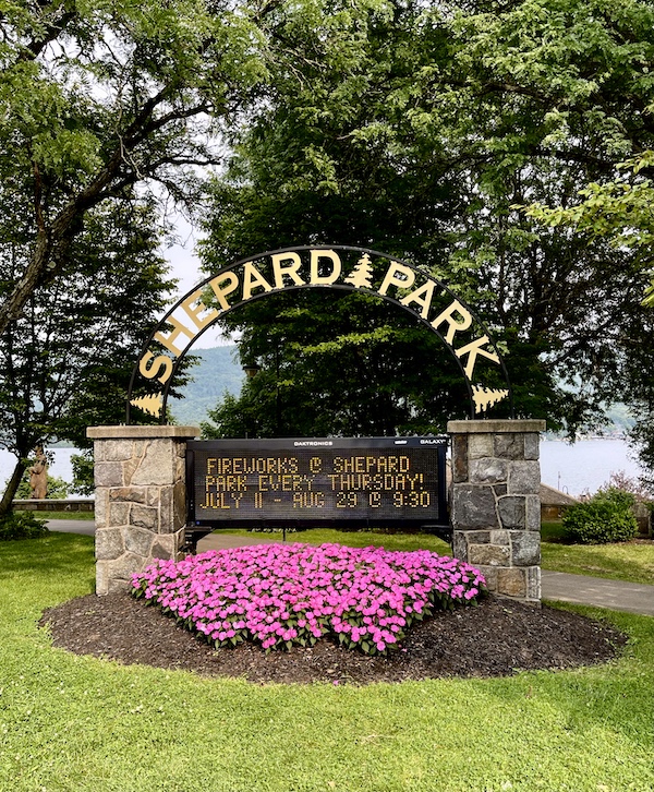 Stone pillars and black iron arch with gold letters welcoming you to Shepard Park