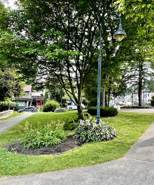 Paved path with landscape that leads to the beach in Lake George New York