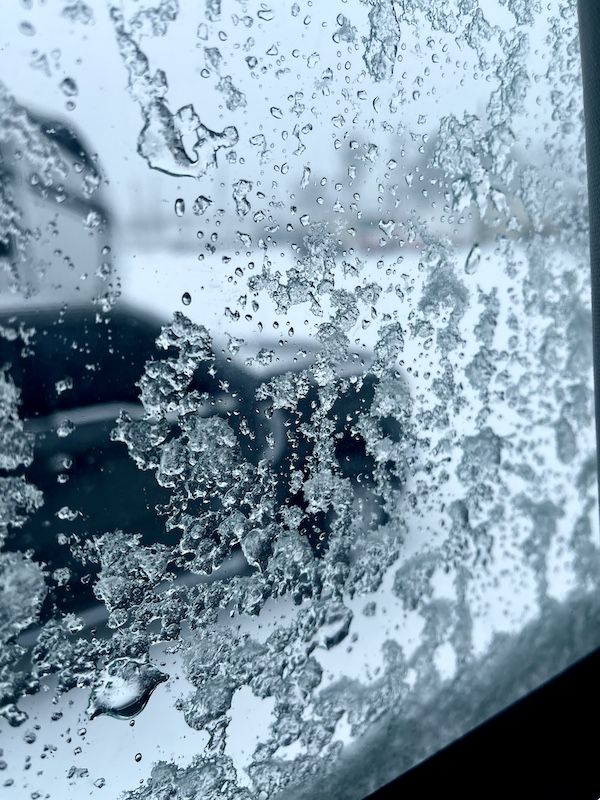 Window looking out on RV park during a snow storm is covered with ice. A reason NOLA Should be Renamed SNOWLA!