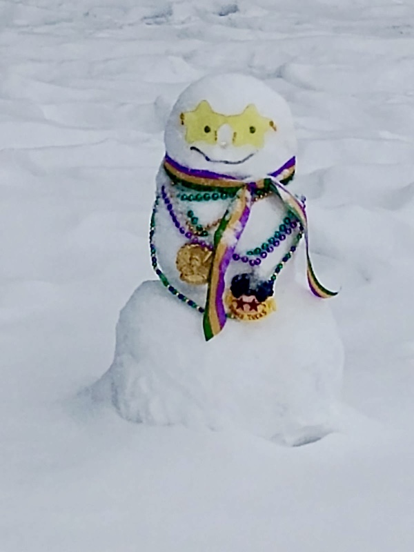 NOLA Should be Renamed SNOWLA! Enough snow to build a snowman with yellow glasses and mardi gras beads