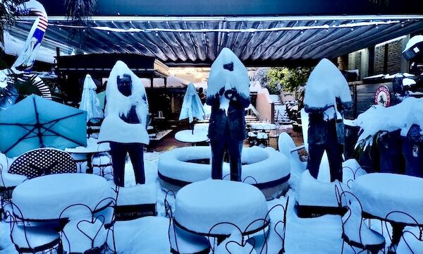 NOLA Should be Renamed SNOWLA!Trio of statues of famous NOLA musicians covered in snow, as well as tables and chairs piled with snow.