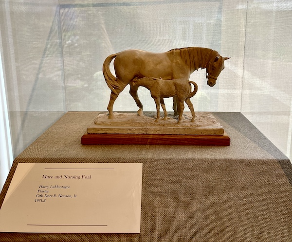 Plaster sculpture of a mare and her nursing foal.