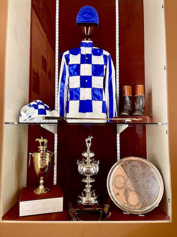 Trophy's of Secretariat and blue and white silks of his jockey on display at the National Museum of Racing and Hall of Fame