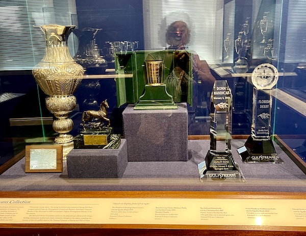 Display case of assorted trophies from Florida horse races