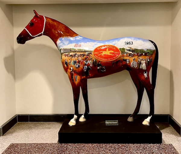 Colorfully painted fiberglass horse sculpture representing 150 years of horse racing