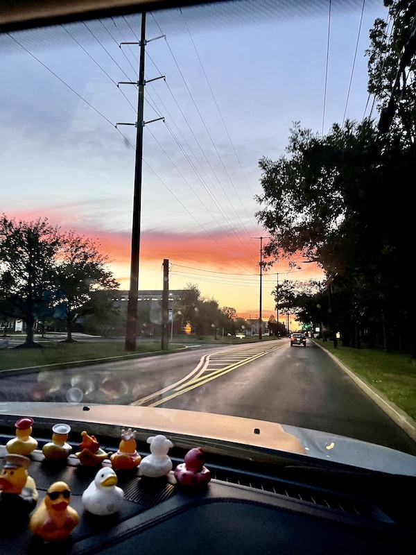 East Coast Here We Come, sunset seen through the windshield of our Jeep with our duckies.