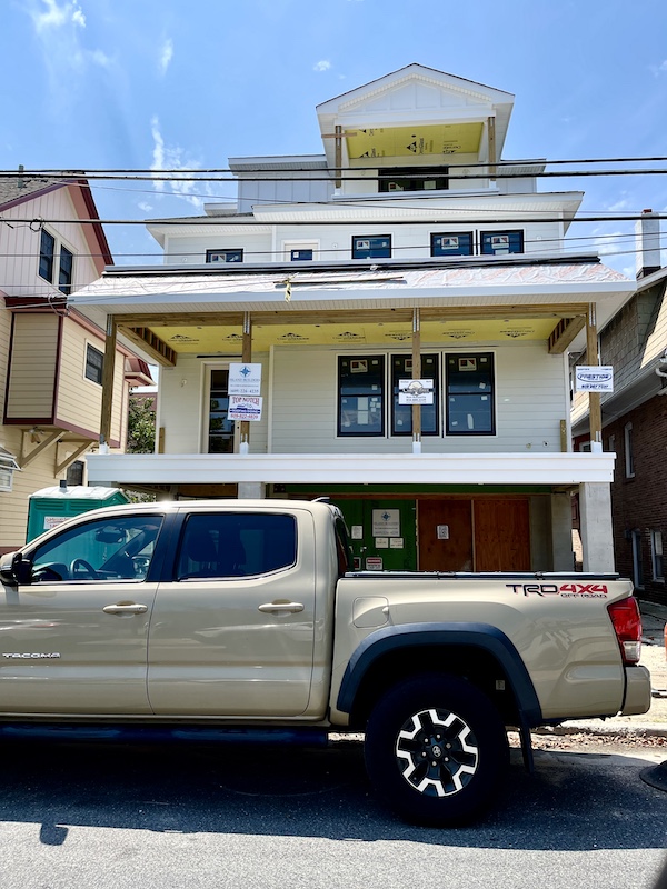East Coast Here We Come, pick up truck in front of multistory house that's under construction 