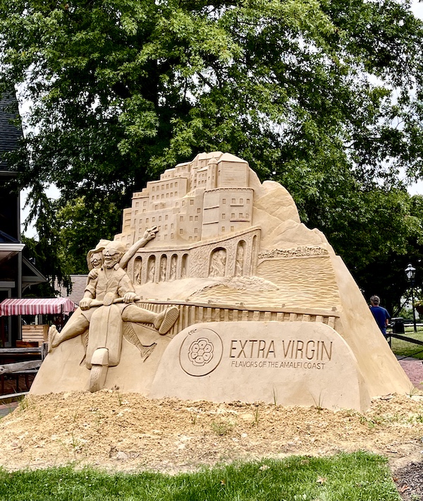 One of the Sand Sculptures Peddler's Village shows a couple of tourists on a scooter in front of Italian buildings