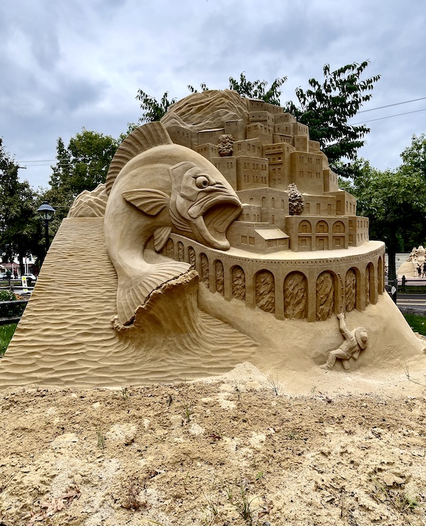 The other side of Extra Virgin's sculpture at Peddler's Village shows more Italian architecture and a little boy catching a giant fish