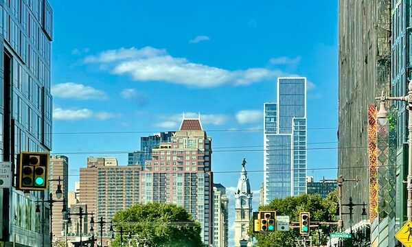 Cityscape with tall buildings trees and blue sky on our Tour of Downtown Philadelphia