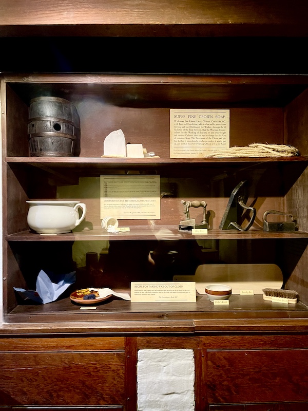 Wood shelves displaying antique iron and other memorabilia see while Visiting Betsy Ross' House