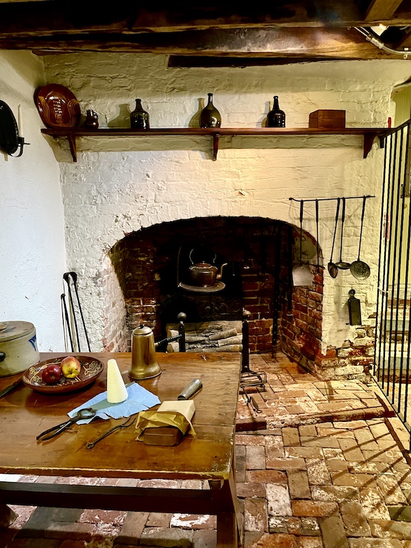 Fireplace, table, benches and other kitchen items seen while Visiting Betsy Ross' House