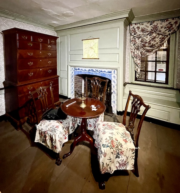 Dark wood cabinet, table, 2 chairs and fireplace with Delft tiles seen while Visiting Betsy Ross' House