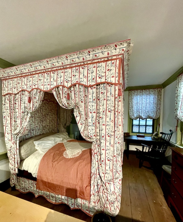 Canopy bed with print drapery and peach quilt seen while Visiting Betsy Ross' House