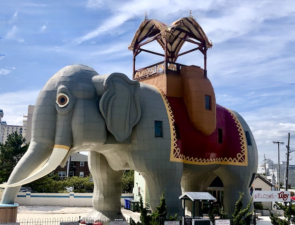 Huge elephant building with red and gold carriage top.