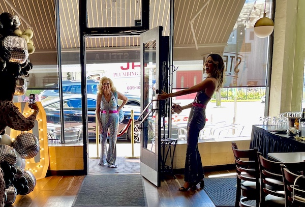 Girl holding the door open for a woman to enter. More of our Autumn Memories at Jersey Shore