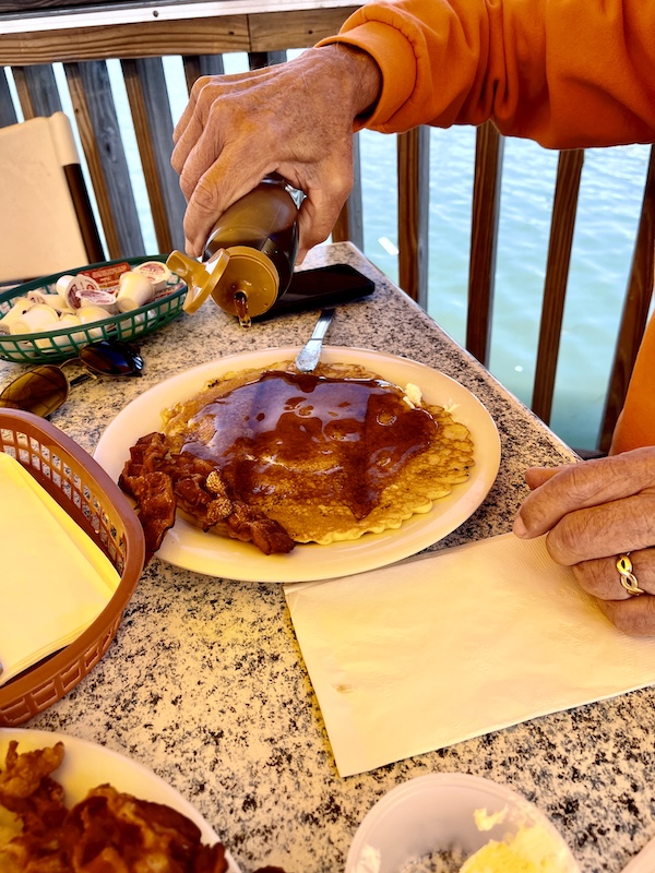 Man pourtant syrup on his stack of pancakes during our Autumn Memories at Jersey Shore