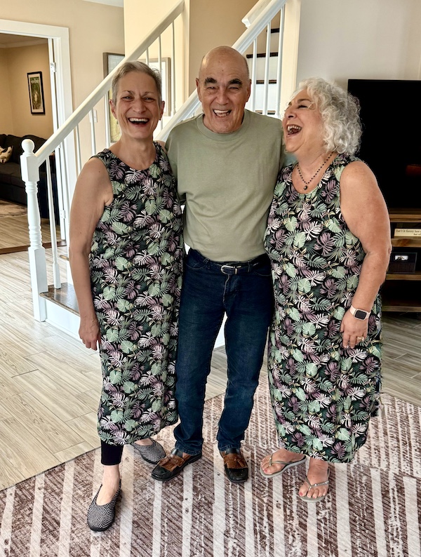 Two women in the same dress with leaf print and Steve in the middle.