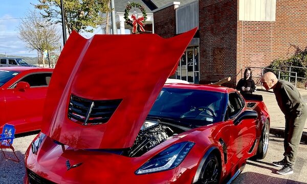 Bright red sports car with hood open to show off the engine at the Downtown Pickens Car Show