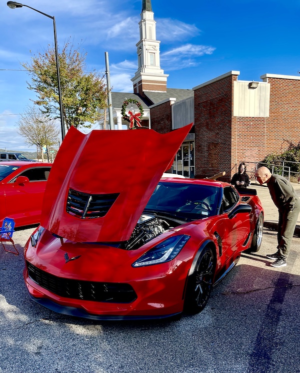 Bright red sports car with hood open to show off the engine at the Downtown Pickens Car Show