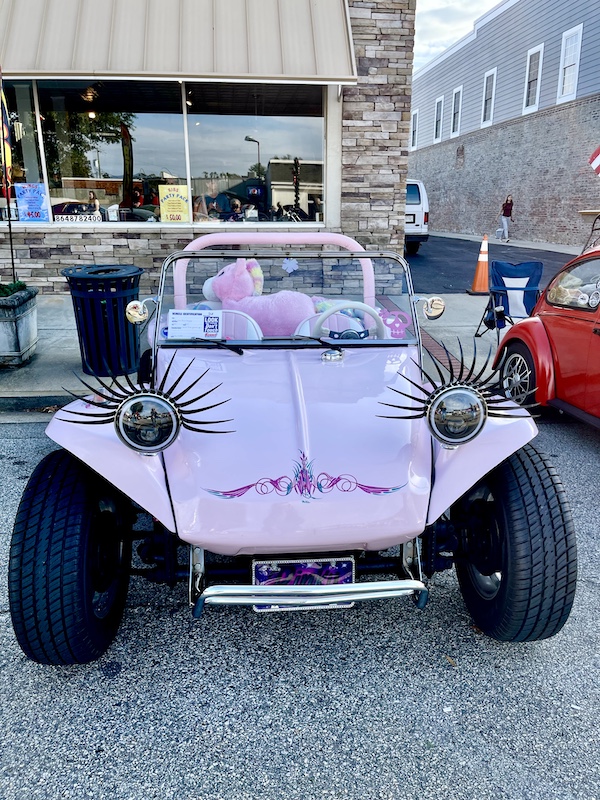 Pink dune buggy with long black lashes on headlights at the Downtown Pickens Car Show