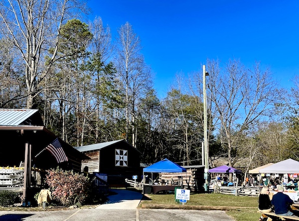 Lawn and trees with exhibit tents set up for the Hagood Mill Native American Celebration