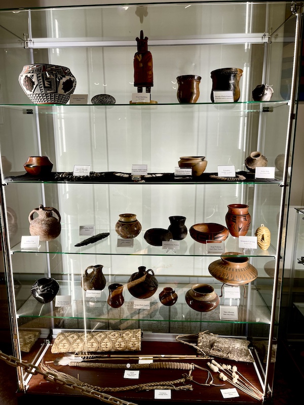 Glass display case filled with native American artifacts at Hagood Mill Native American Celebration