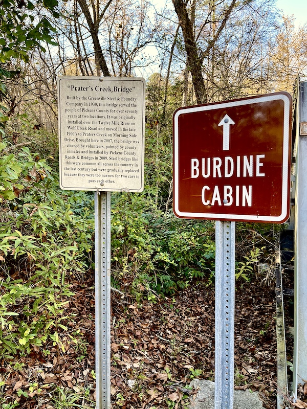 Sign in woods for Burdine Cabin