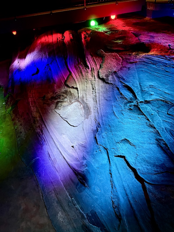 Colorful lights projected onto rocks during the Hagood Mill Native American Celebration