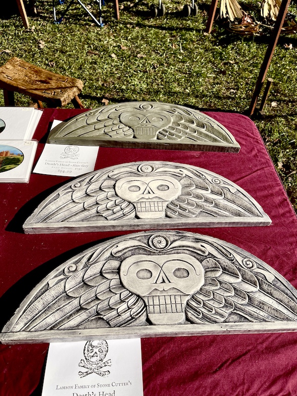 Half circle stone cutting of scull on red tablecloth at the Hagood Mill Native American Celebration