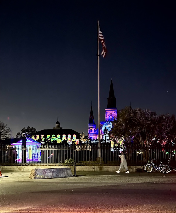 Park with building lit in colorful display shows Celebrating Super Bowl NOLA Style