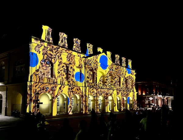 Leopards with blue and yellow projected on church facade