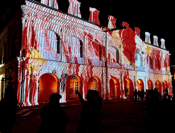Red and pale blue patterns projected on church front shows Celebrating Super Bowl NOLA Style