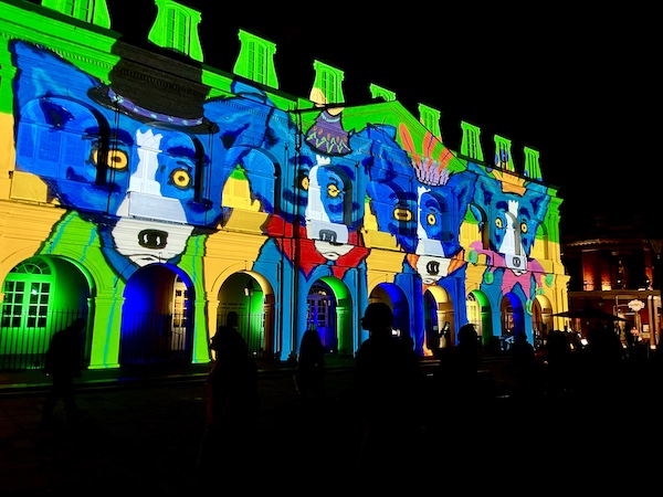 Several blue dogs projected on church facade 