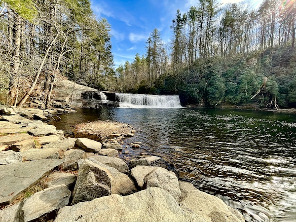 View of waterfalls, rocks and trees.